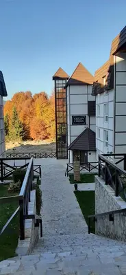 a row of benches in front of a building at Kraljevi čardaci, apartman 53 u zgradi 7, opcija unutrašnjeg parking mesta in Kopaonik