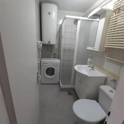a small bathroom with a toilet and a sink at Apartman Marger in Niš