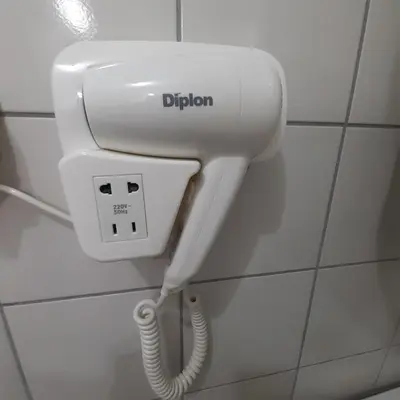 a phone with the word dijon on a wall at Apartman Marger in Niš