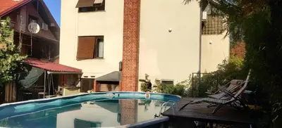a swimming pool in front of a building at Hostel Golub in Zaječar