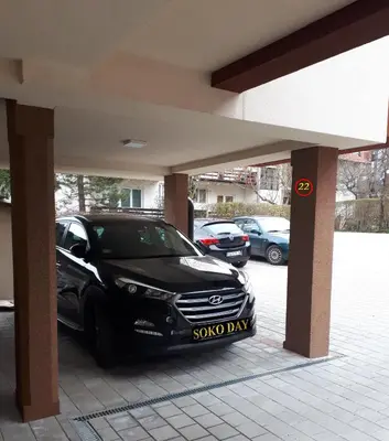 a black car parked in a parking lot at Apartmani Soko Day 1 in Soko Banja