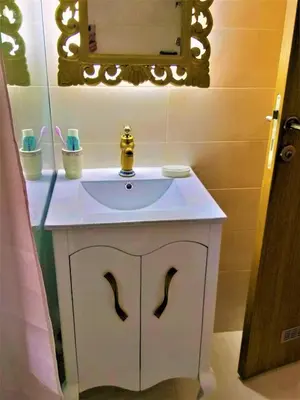 a bathroom with a white sink and a mirror at Apartmani Soko Day 1 in Soko Banja