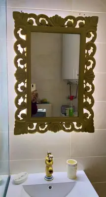 a person taking a picture of a mirror over a sink at Apartmani Soko Day 1 in Soko Banja