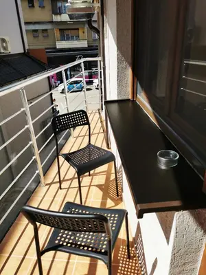 two chairs and a table on a balcony at Lux Family Apartment Vidanovic in Pirot