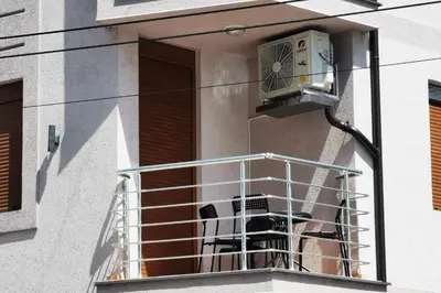 a balcony with a air conditioner on a building at Lux Family Apartment Vidanovic in Pirot