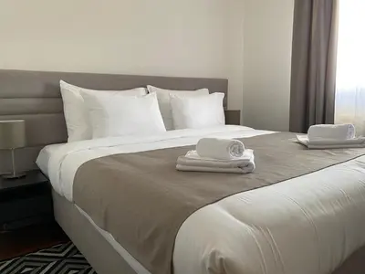 a bedroom with a bed with two towels on it at Apartman Luka in Vrnjačka Banja