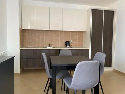 a kitchen with a table and chairs in a room at Apartman Luka in Vrnjačka Banja