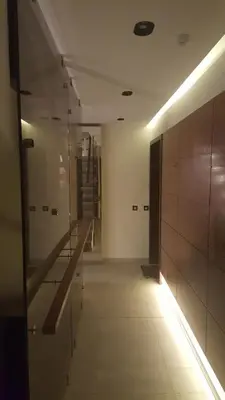 a hallway with a staircase in a building with lights at Apartman A7 u vili Pahulja in Kopaonik