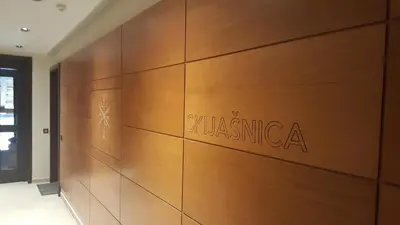 a wooden wall with the name of a building at Apartman A7 u vili Pahulja in Kopaonik