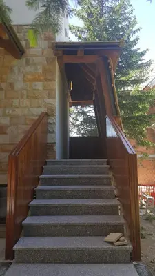a set of stairs leading up to a building at Apartman A7 u vili Pahulja in Kopaonik