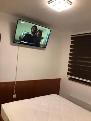 a bedroom with a flat screen tv on the wall at Apartman B3 u vili Suri in Kopaonik