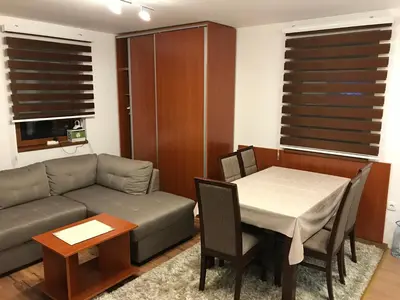 a living room with a couch and a table at Apartman B3 u vili Suri in Kopaonik