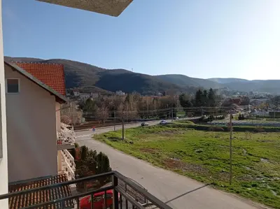 a balcony with a view of a road and mountains at Apartman Sunce in Soko Banja