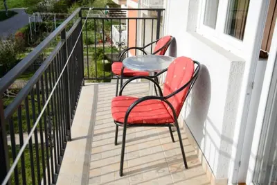 two chairs and a table on a balcony at Apartman Sunce in Soko Banja