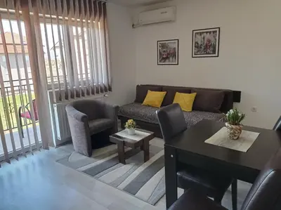 a living room with a couch and a table at Apartman Sunce in Soko Banja