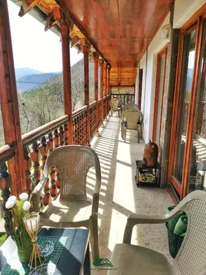a porch with chairs and a table on a house at Villa Balconlux - Zavojsko jezero, Pirot in Pirot