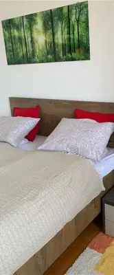 a bed in a bedroom with a picture on the wall at Belvedere in Niš