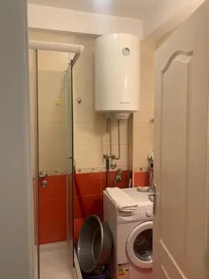 a small kitchen with a washer and a washing machine at Belvedere in Niš