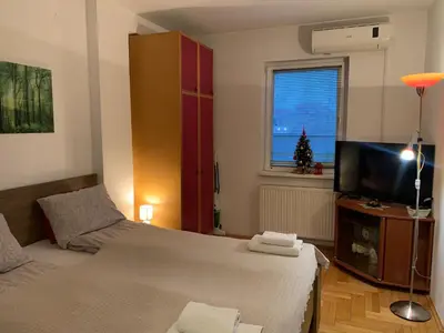 a bedroom with a bed and a flat screen tv at Belvedere in Niš