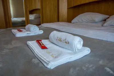 two beds with towels on them on a bed at Vila Čair in Balajnac