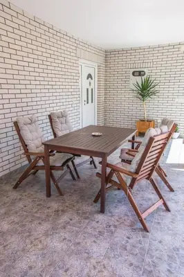 a wooden table and two chairs in a room at Vila Čair in Balajnac
