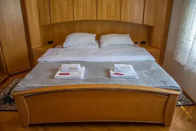a bed with two towels sitting on top of it at Vila Čair in Balajnac