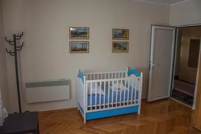 a baby crib in a room with at Vila Čair in Balajnac