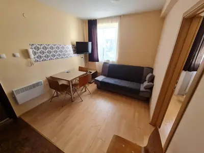 a living room with a couch and a table at Cosy apartment Marina in Kopaonik
