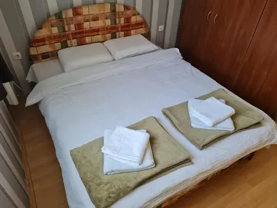 a white bed with towels on top of it at Cosy apartment Marina in Kopaonik