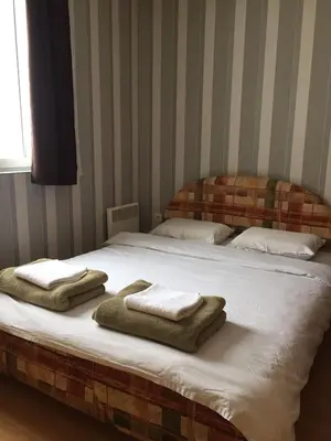 a bed with towels on it in a bedroom at Cosy apartment Marina in Kopaonik
