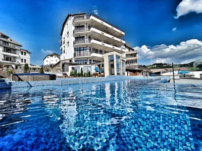 a swimming pool in front of a building at Milmari S70 Kopaonik in Kopaonik