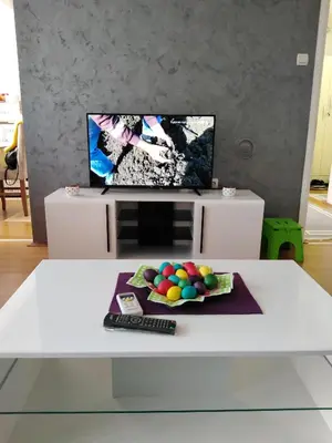 a white coffee table with a remote control and balls on it at Rudolf apartmani in Soko Banja