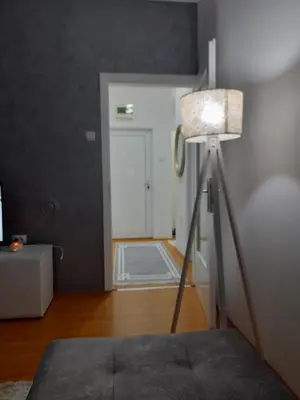 a room with a lamp and a white door at Rudolf apartmani in Soko Banja