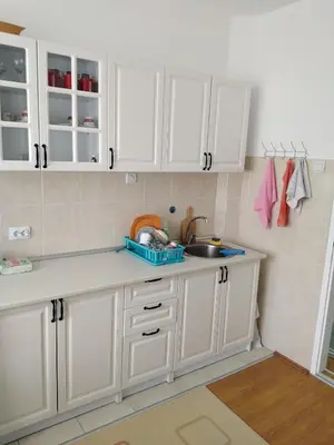 a kitchen with white cabinets and a sink at Rudolf apartmani in Soko Banja