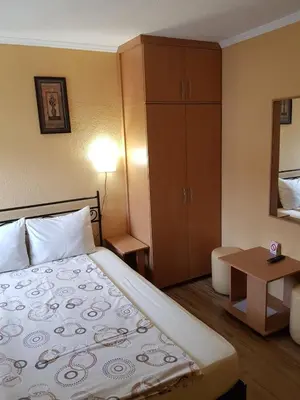 a hotel room with a bed and a table at Etno kuca sa konacistem GOCKO in Vrnjačka Banja