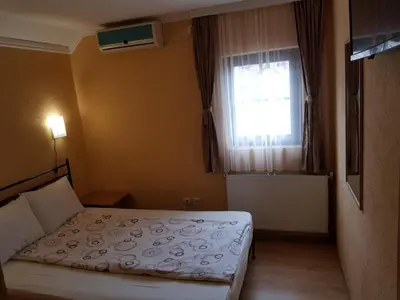a small bedroom with a bed and a window at Etno kuca sa konacistem GOCKO in Vrnjačka Banja