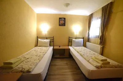 a room with two beds and a desk and a window at Etno kuca sa konacistem GOCKO in Vrnjačka Banja