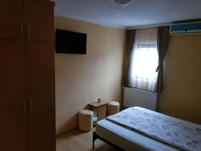 a small bedroom with a bed and a window at Etno kuca sa konacistem GOCKO in Vrnjačka Banja