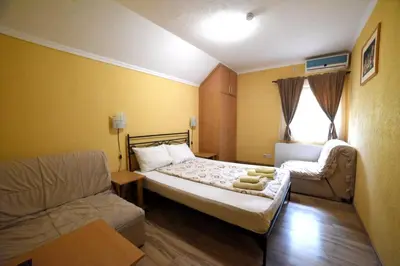 a small room with a bed and a couch at Etno kuca sa konacistem GOCKO in Vrnjačka Banja