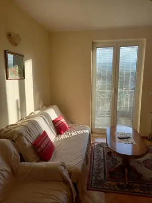a living room with a couch and a coffee table at Apartmani Ivančica in Vrnjačka Banja