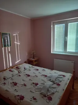 a bedroom with a bed with flowers on it at Apartmani Ivančica in Vrnjačka Banja