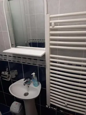 a small bathroom with a sink and a mirror at Apartmani Ivančica in Vrnjačka Banja