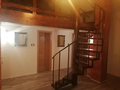 a spiral staircase in a room with a brick wall at Apartman Daša in Soko Banja