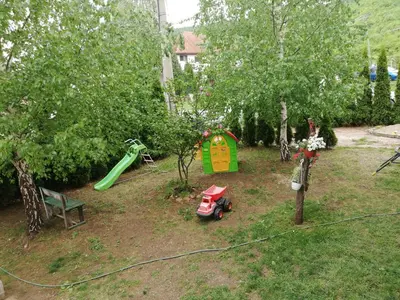 a playground with a toy car and a play house at Apartman Daša in Soko Banja