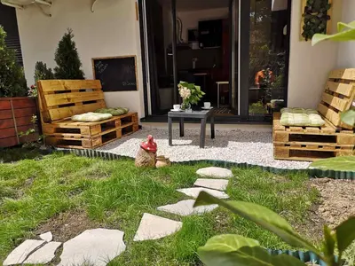 a garden with a fire hydrant in the grass at B3 Sneznik-Modern apartment in Vrnjačka Banja