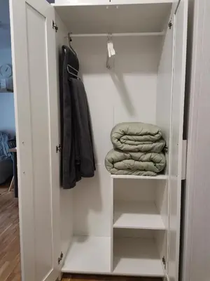 a white closet with some folded towels in it at B3 Sneznik-Modern apartment in Vrnjačka Banja