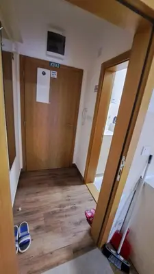 a hallway with a door and some shoes on the floor at Studio Soko Day 2 in Soko Banja