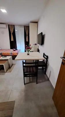 a table and chairs in a room with a bedroom at Studio Soko Day 2 in Soko Banja