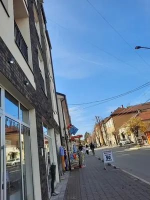 a street with people standing outside of a store at Studio Soko Day 2 in Soko Banja