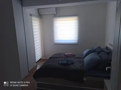 a bedroom with a bed and a window at Malevilla Apartment in Vrnjačka Banja